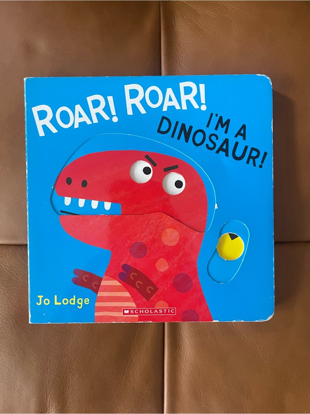 Scholastic Blue Board Book with Red Dinosaur and Yellow Tab